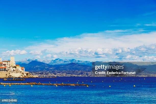 blue mediterranean landscape and antibes old town and coastline - antibes stock-fotos und bilder