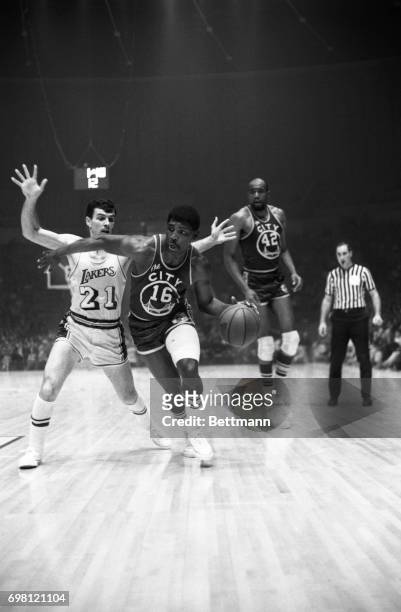 San Francisco guard, Al Attles goes right past Los Angeles guard Johnny Egan to score in the first quarter at the Forum. Also shown is San Francisco...