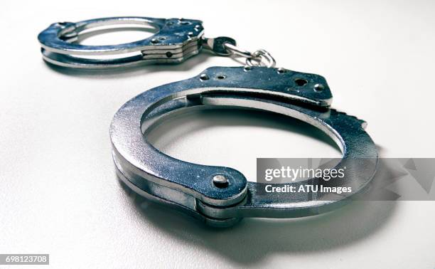 handcuffs wide angle - handboeien stockfoto's en -beelden