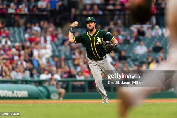 Third baseman Trevor Plouffe of the Oakland Athletics throws out Bradley Zimmer of the Cleveland Indians at first to end the eighth inning at...