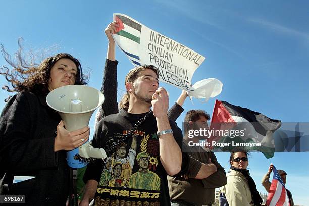 Protesters address israeli soldiers by megaphone during a demonstration near Yasser Arafats headquarters February 5, 2002 in the West Bank town of...