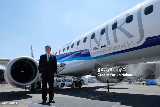 Shunichi Miyanaga, poses outside Mitsubishi Regional Jet at the Le Bourget Airport, a day before the opening of the 2017 Paris Air Show on June18 in...