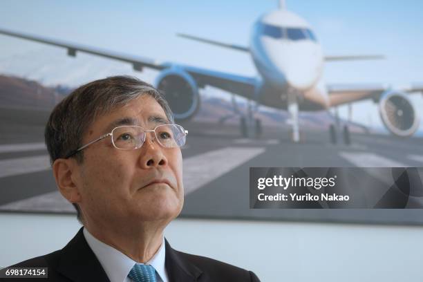 Shunichi Miyanaga, poses outside Mitsubishi Regional Jet at the Le Bourget Airport, a day before the opening of the 2017 Paris Air Show on June18 in...