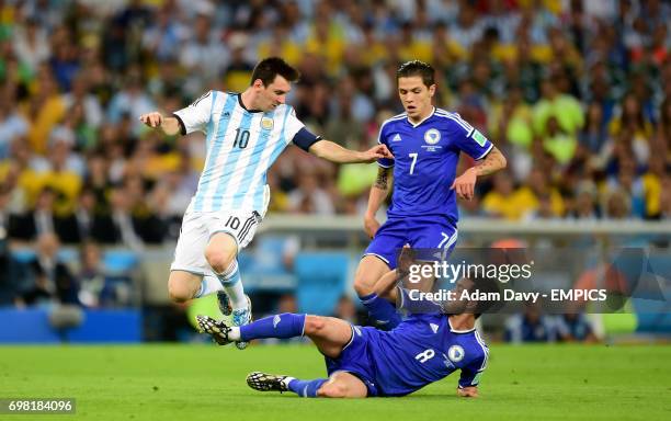 Argentina's Lionel Messi and Bosnia and Herzegovina's Miralem Pjanic battle for the ball