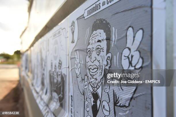 View of posters on a wall showing caricatures of various football related celebrities including Pele.