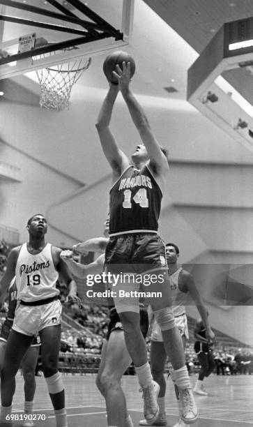 Warriors' Tom Meschery drives past two Piston players, Ray Scott and Joe Strawder , to score during the 1st period of the Detroit-San Fransisco game...