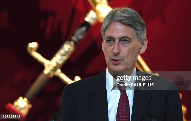 Britain's Chancellor of the Exchequer Philip Hammond delivers his re-scheduled speech to the Bankers and Merchants of the City of London, during a...