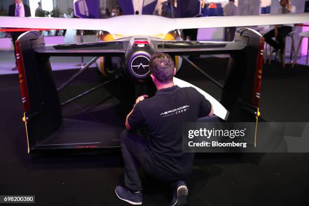 An employee fixes a propeller to an AeroMobil flying car as it stands on display during the 53rd International Paris Air Show at Le Bourget, in...