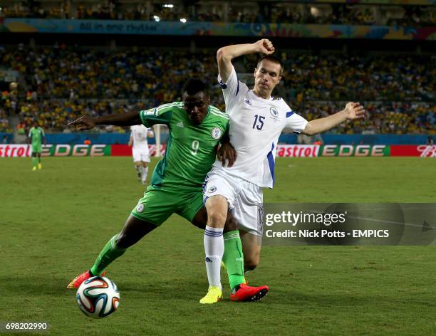 Nigeria's Emmanuel Emenike and Bosnia & Herzegovina's Toni Sunjic battle for the ball