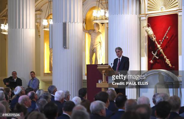 Britain's Chancellor of the Exchequer Philip Hammond delivers his re-scheduled speech to the Bankers and Merchants of the City of London, during a...
