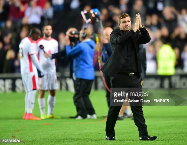 Milton Keynes Dons' manager Karl Robinson applauds the fans after the match.