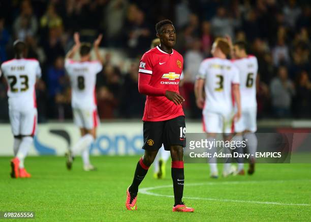 Manchester United's Danny Welbeck walks off the pitch dejected.