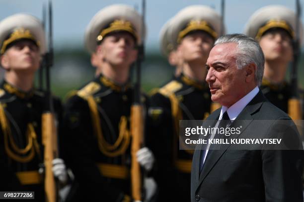 Brazilian President Michel Temer reviews an honour guard upon his arrival at Moscow's Vnukovo Airport on June 20, 2017. / AFP PHOTO / Kirill...