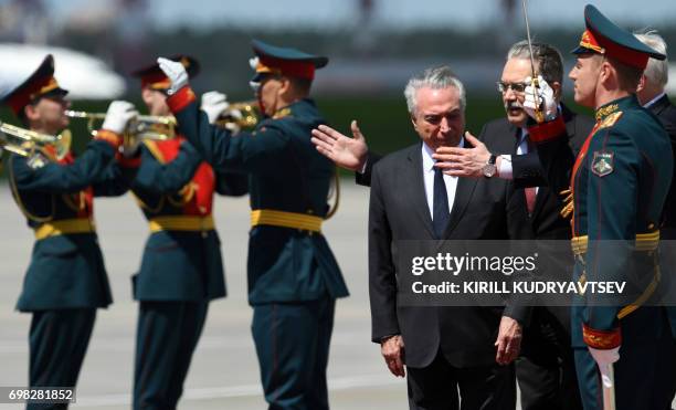 Brazilian President Michel Temer reviews an honour guard upon his arrival at Moscow's Vnukovo Airport on June 20, 2017. / AFP PHOTO / Kirill...