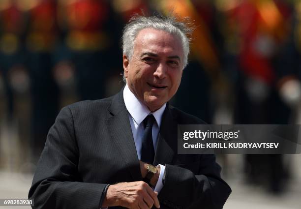 Brazilian President Michel Temer reviews an honour guard upon his arrival at Moscow's Vnukovo Airport on June 20, 2017. / AFP PHOTO / Kirill...