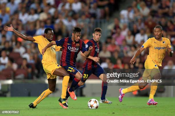 Apoel Nicosia's Franco Vinicius and Barcelona's Junior Neymar battle for the ball.