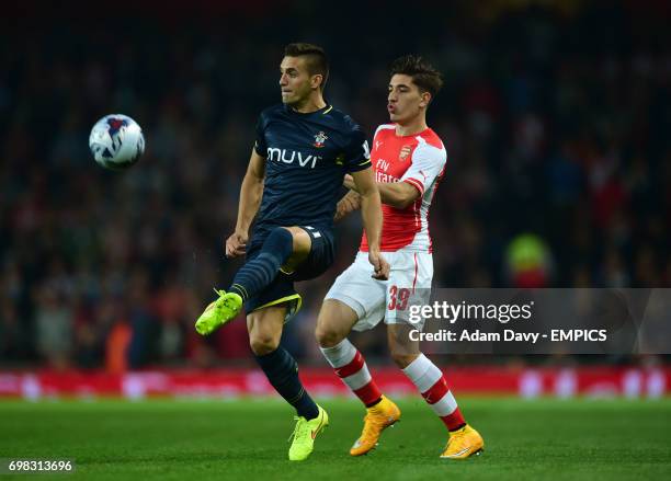 Arsenal's Hector Bellerin and Southampton's Dusan Tadic battle for the ball