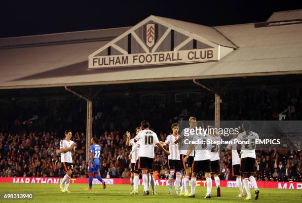 Fulham's Bryan Ruiz is mobbed by team mates as he celebrates scoring the opening goal