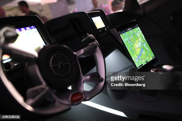 Touch-screen tablet device displaying a map sits beside the steering column of an AeroMobil flying car on display at the 52nd International Paris Air...