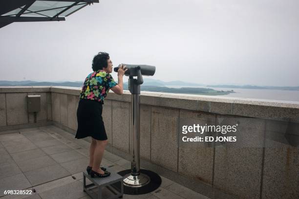 Visitor looks through binoculars towards North Korea at the Odusan observatory, near the Demilitarized Zone separating North and South Korea, in Paju...