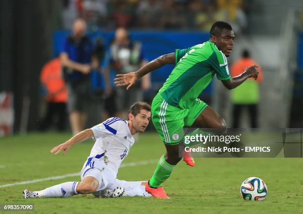 Bosnia and Herzegovina's Haris Medunjanin and Nigeria's Emmanuel Emenike battle for the ball