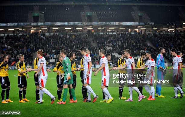 Sheffield United and MK Dons players shake hands prior to kick off.
