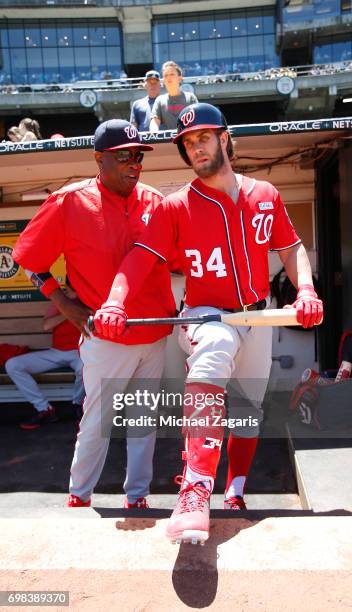 Manager Dusty Baker and Bryce Harper of the Washington Nationals talk in the dugout prior to the game against the Athletics at the Oakland Alameda...