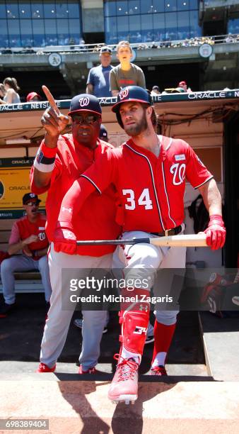 Manager Dusty Baker and Bryce Harper of the Washington Nationals talk in the dugout prior to the game against the Athletics at the Oakland Alameda...