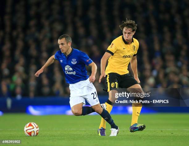 Everton's Leon Osman and Lille's Michael Lecinena battle for the ball