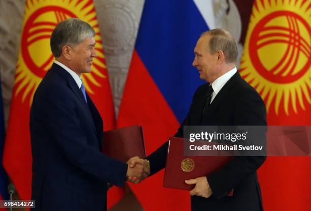 Russian President Vladimir Putin greets Kyrgyz President Almazbek Atambayev during their talks at the Grand Kremlin Palace on June 20, 2017 in...