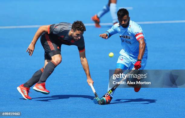 Manpreet Singh of India and Valentin Verga of the Netherlands battle for the ball during the Pool B match between India and the Netherlands on day...