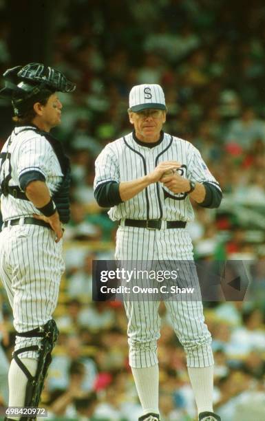 Carlton Fisk and manager Jeff Torborg have a meeting on the mound in a turn back the clock game against the Milwaukee Brewers wearing 1919 uniforms...