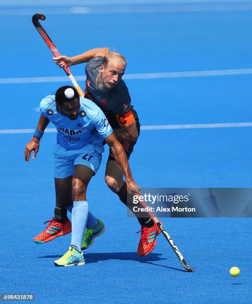 Billy Bakker of the Netherlands and Akashdeep Singh of India battle for the ball during the Pool B match between India and the Netherlands on day six...