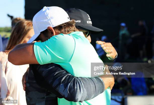 Brooks Koepka of the United States hugs coach Claude Harmon after winning the 2017 U.S. Open at Erin Hills on June 18, 2017 in Hartford, Wisconsin.