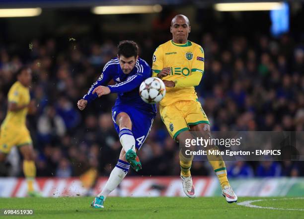 Chelsea's Cesc Fabregas and Sporting Lisbon's Joao Mario battle for the ball.