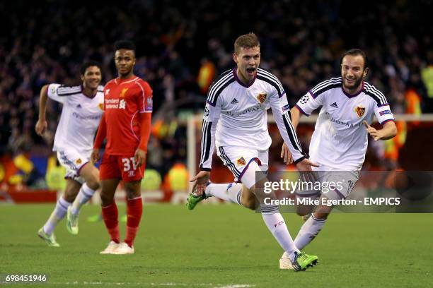 Basel's Fabian Frei celebrates with team mate Shkelzen Gashi after scoring his sides first goal of the game whilst Liverpool's Raheem Sterling looks...