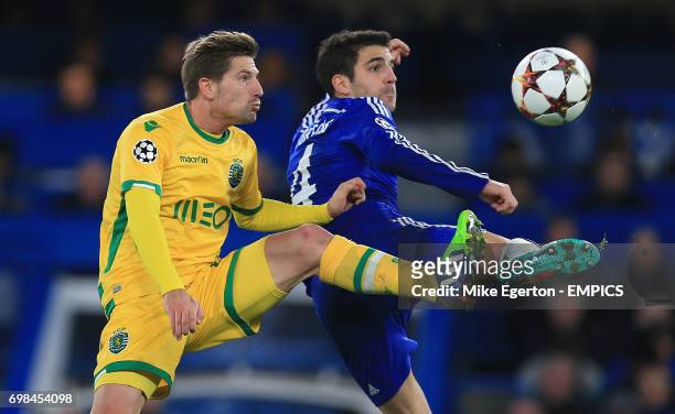Chelsea's Cesc Fabregas and Sporting Lisbon's Adrien Silva battle for the ball in the air.