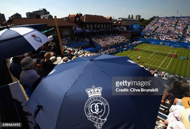 General view on Centre Court as fans shield from the sun during the mens singles first round match between Stan Wawrinka of Switzerland and Feliciano...