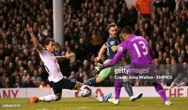 Newcastle United's Adam Armstrong has a shot which is blocked by Tottenham Hotspur's Benjamin Stambouli and Michel Vorm