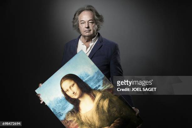 French writer, journalist and artist Gonzague Saint Bris poses with his digital art piece titled "The blue Joconde" during a photo session on June 7,...