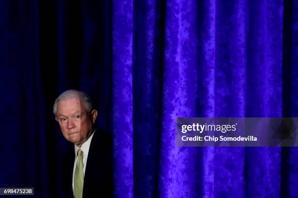 Attorney General Jeff Sessions walks out from backstage during the National Summit on Crime Reduction and Public Safety at the Hyatt Regency hotel...