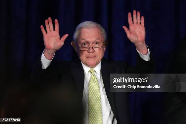 Attorney General Jeff Sessions waves after addressing the National Summit on Crime Reduction and Public Safety at the Hyatt Regency hotel June 20,...