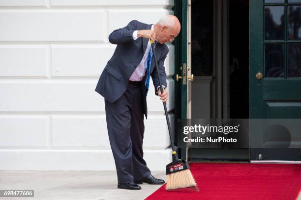 White House usher Daniel Shanks sweeps the red carpet in preparation for the arrival of President Juan Carlos Varela and Mrs. Lorena Castillo Varela...