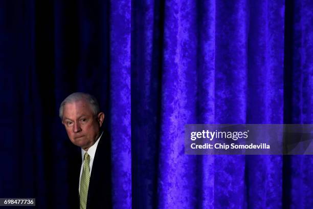 Attorney General Jeff Sessions walks out from backstage during the National Summit on Crime Reduction and Public Safety at the Hyatt Regency hotel...