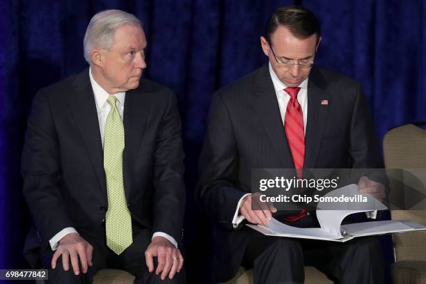 Attorney General Jeff Sessions and Deputy Attorney General Rod Rosenstein sit next to each other on stage during the National Summit on Crime...