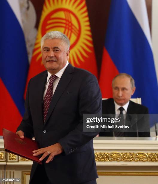 Russian President Vladimir Putin looks on Interior Minister Vladimir Kolokoltsev during Russian-Kyrgyz talks at the Grand Kremlin Palace on June 20,...