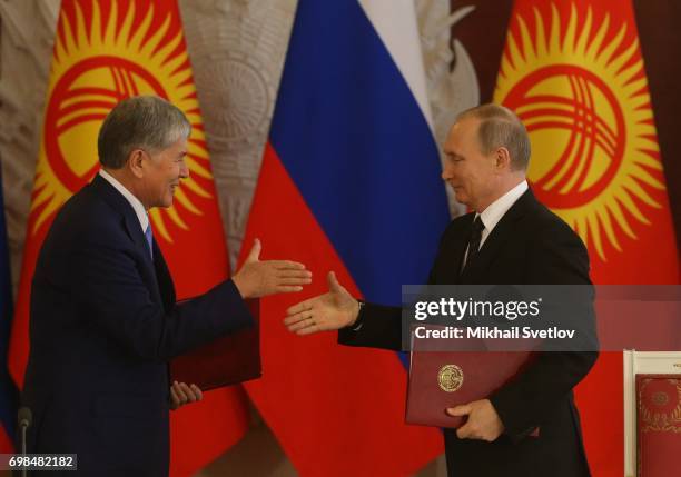 Russian President Vladimir Putin greets Kyrgyz President Almazbek Atambayev during their talks at the Grand Kremlin Palace on June 20, 2017 in...