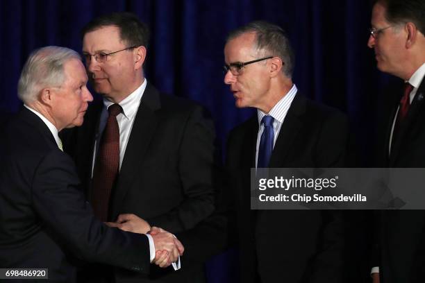 Attorney General Jeff Sessions shakes hands with Drug Enforcement Administraiton acting head Chuck Rosenberg, Federal Bureau of Investigation Acting...