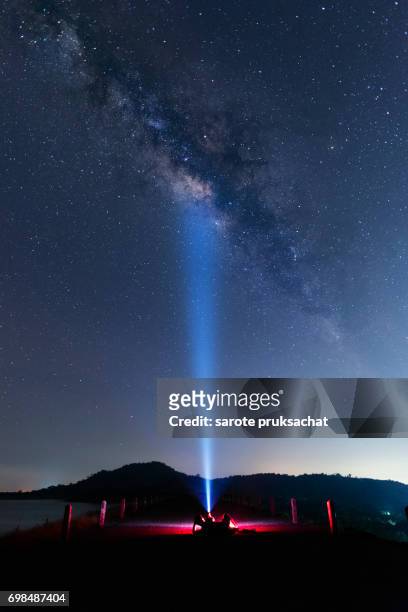 man, flashlights and the milky way , stars light night sky. long exposure photograph with grain . - osservatorio foto e immagini stock