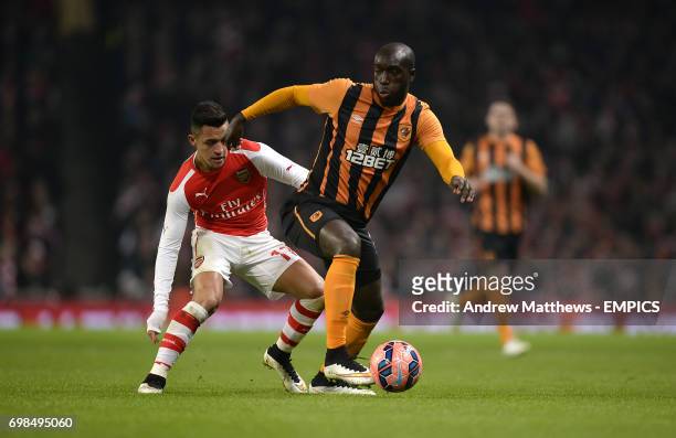 Hull City's Yannick Sagbo and Arsenal's Alexis Sanchez battle for the ball